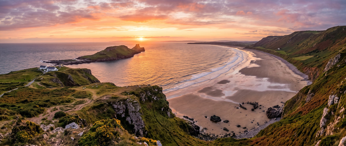 Sunset over Rhossili Bay and Worm's Head on the Gower coast, with the beach and shipwreck below